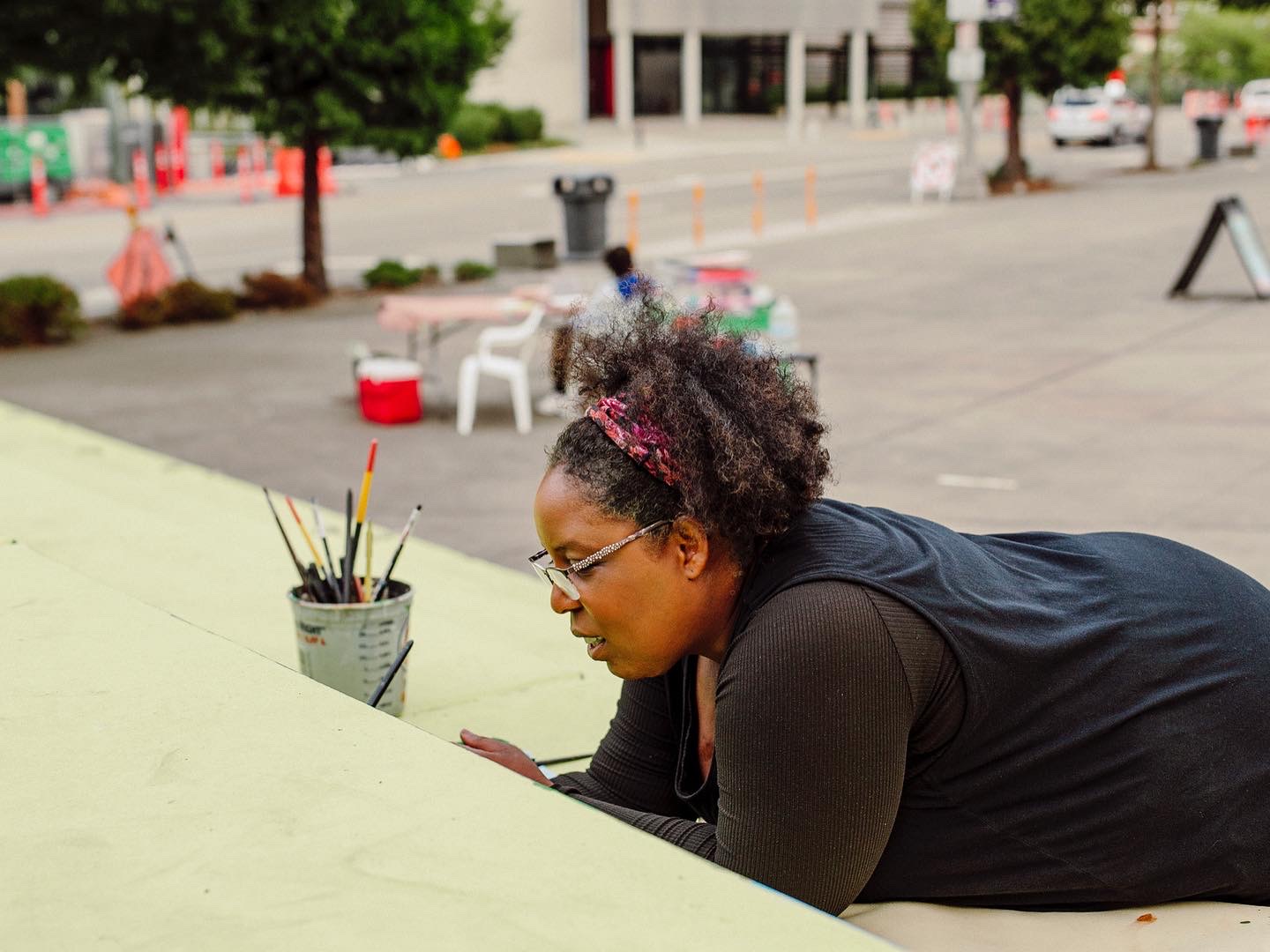 Dionne Bonner painting the Black Lives Matter Mural in Tacoma Washington that she led and designed with a group of artists and the community.